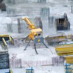 Yellow and black heavy equipment on snow covered ground